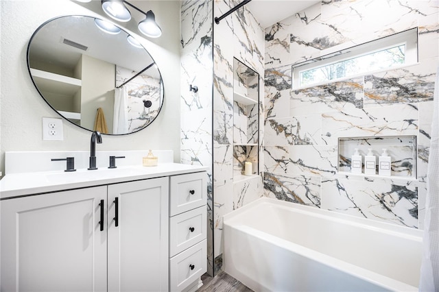 bathroom featuring vanity, wood-type flooring, and shower / tub combo