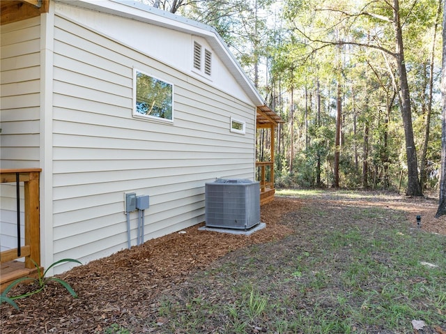 view of side of home with central air condition unit