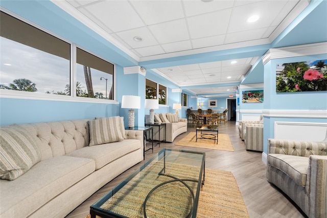 living room with wood-type flooring and ornamental molding