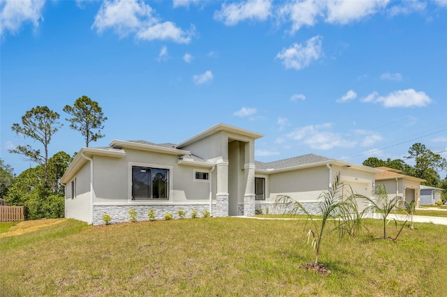 view of front of house featuring a garage and a front lawn