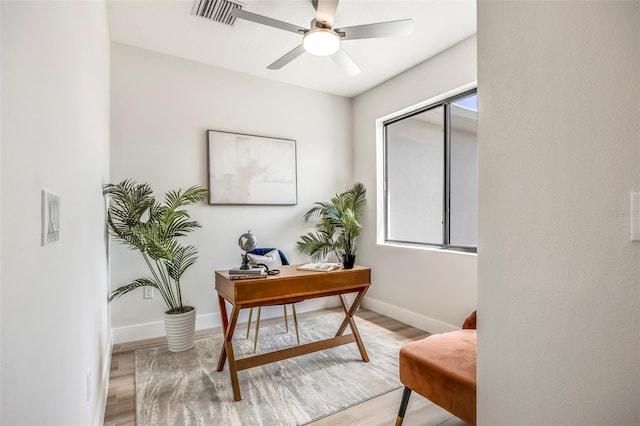 office with ceiling fan and light hardwood / wood-style flooring