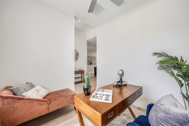 living room with ceiling fan and light hardwood / wood-style flooring