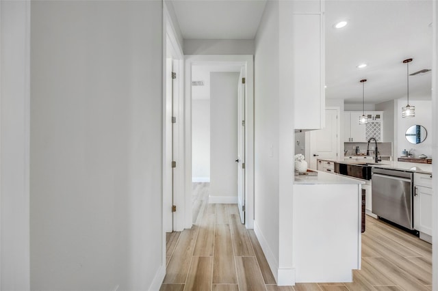 hallway featuring light hardwood / wood-style floors and sink