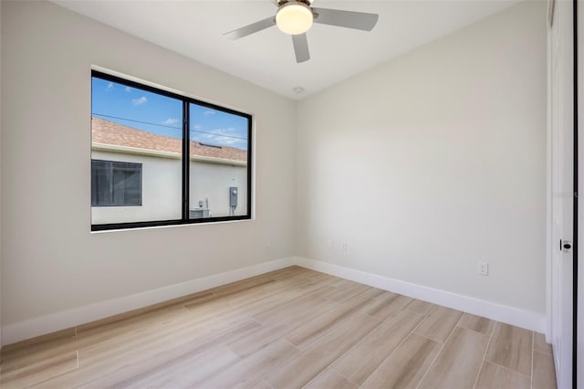 spare room with light wood-type flooring and ceiling fan