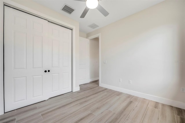 unfurnished bedroom featuring ceiling fan, a closet, and light hardwood / wood-style floors