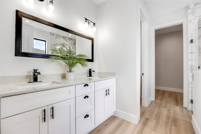 bathroom with vanity, hardwood / wood-style flooring, and walk in shower