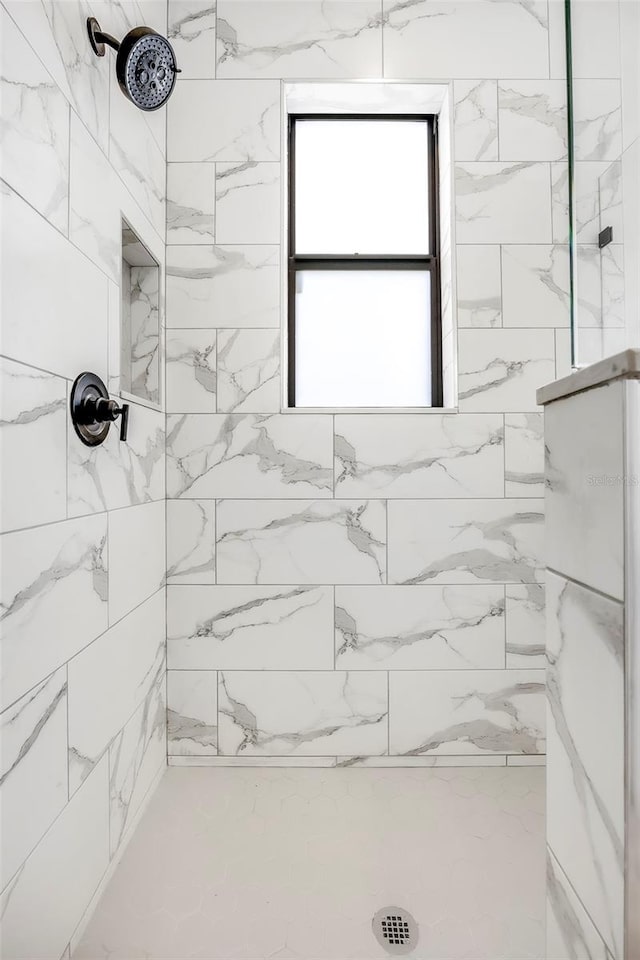 bathroom with a tile shower