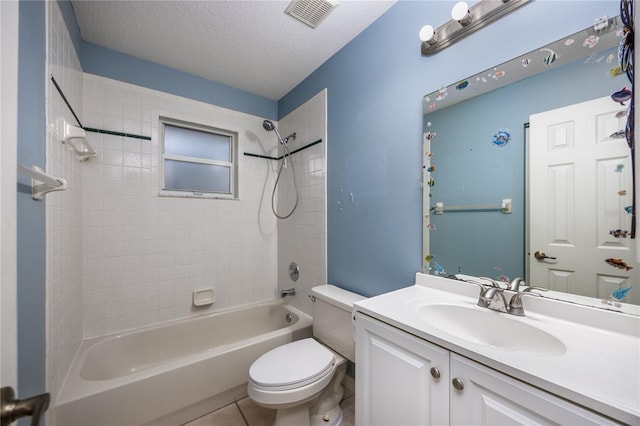 full bathroom with tile patterned floors, a textured ceiling, toilet, vanity, and tiled shower / bath