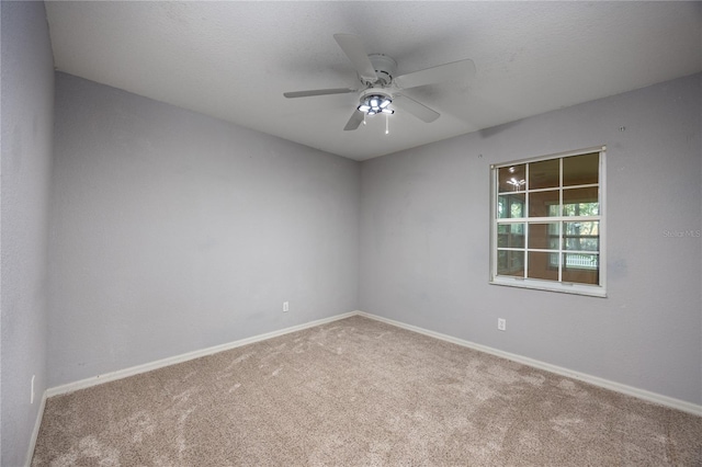 empty room with carpet flooring and ceiling fan