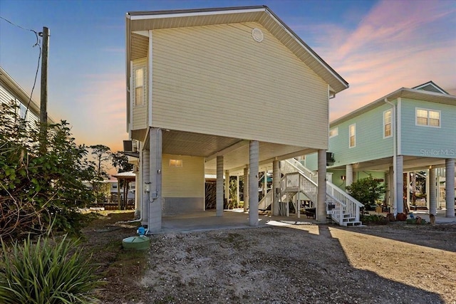 back house at dusk with a carport