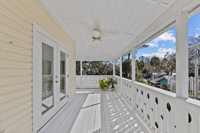 wooden deck with french doors and ceiling fan