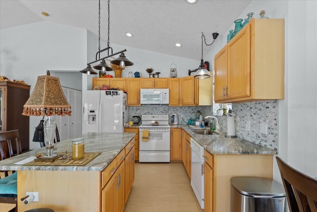 kitchen featuring decorative backsplash, white appliances, vaulted ceiling, and sink