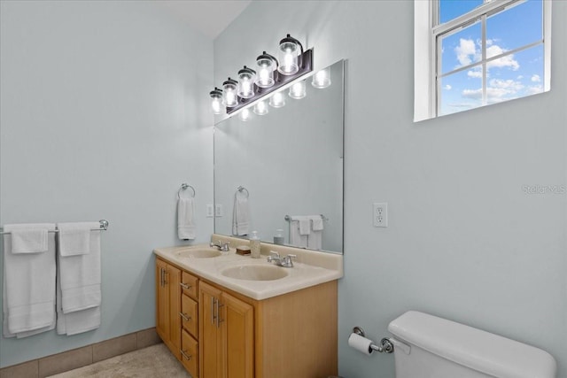 bathroom with tile patterned floors, vanity, and toilet