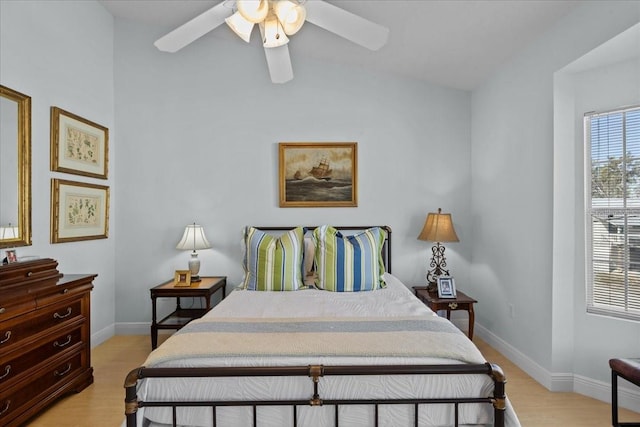 bedroom with light hardwood / wood-style flooring, ceiling fan, and lofted ceiling