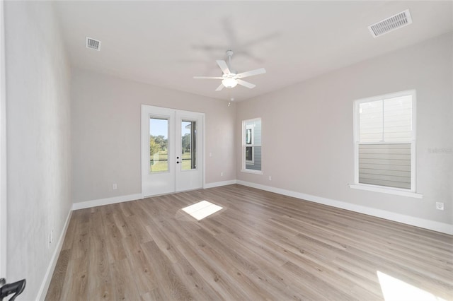 1069 NW 132nd Blvd, Newberry, FL 32669 - spare room featuring french doors, ceiling fan, light wood finished floors, and baseboards
