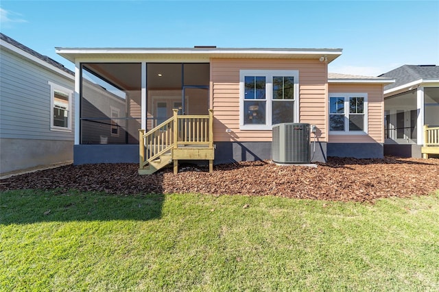 1069 NW 132nd Blvd, Newberry, FL 32669 - back of property with a sunroom, central AC unit, and a lawn
