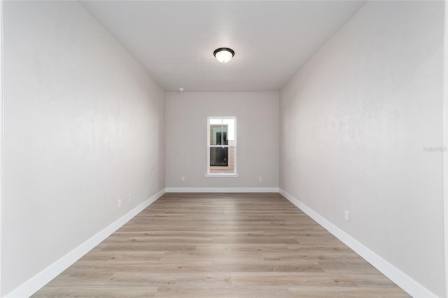 unfurnished room with light wood-type flooring