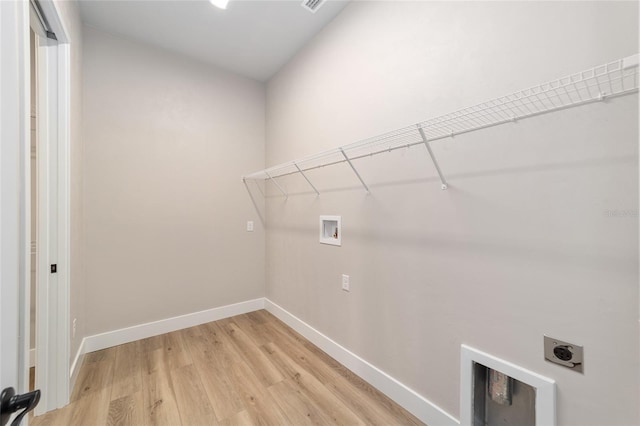 1069 NW 132nd Blvd, Newberry, FL 32669 - laundry area featuring hookup for a washing machine, hookup for an electric dryer, light wood-style flooring, and baseboards