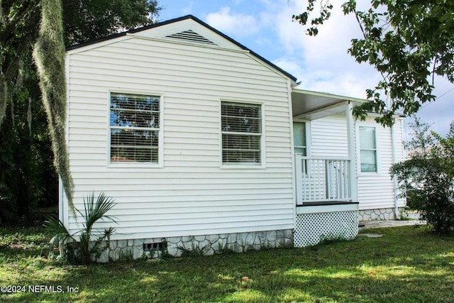 view of property exterior with a lawn