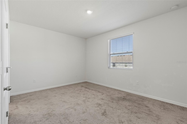 spare room with light colored carpet