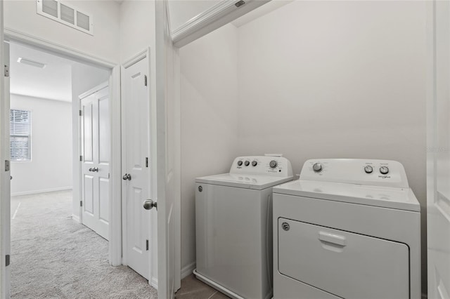 washroom with light carpet and independent washer and dryer