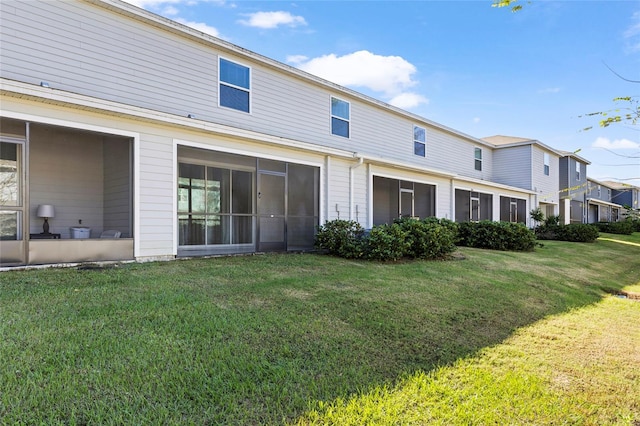 back of property featuring a lawn