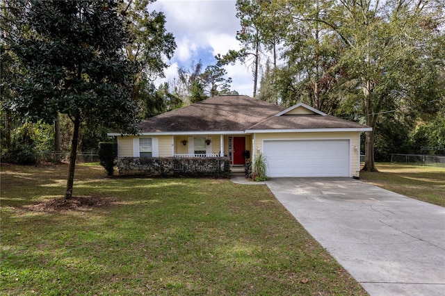 single story home with covered porch, a garage, and a front yard