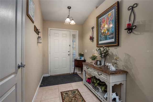 entryway with light tile patterned floors and an inviting chandelier