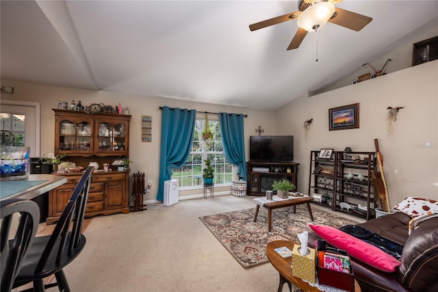 carpeted living room featuring ceiling fan and lofted ceiling