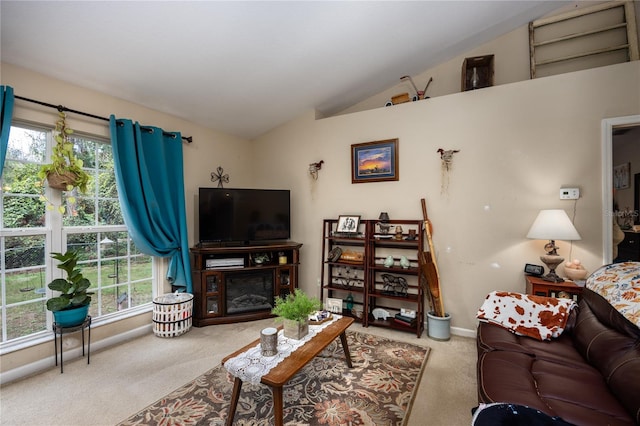 living room featuring plenty of natural light, carpet, and lofted ceiling