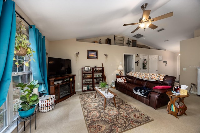 living room featuring ceiling fan, light carpet, and vaulted ceiling