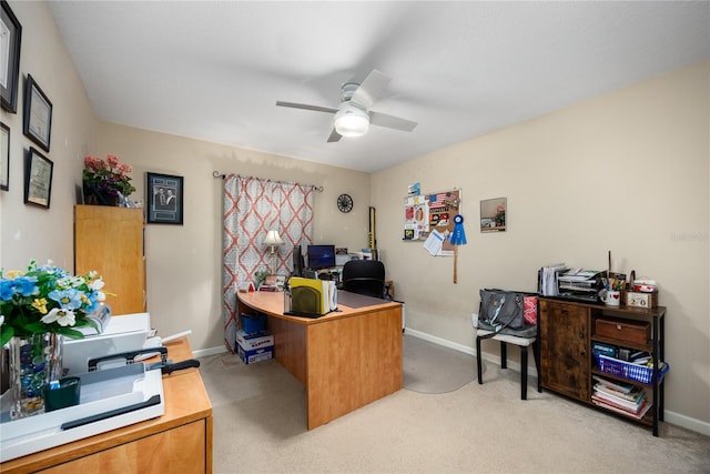 carpeted office space featuring ceiling fan