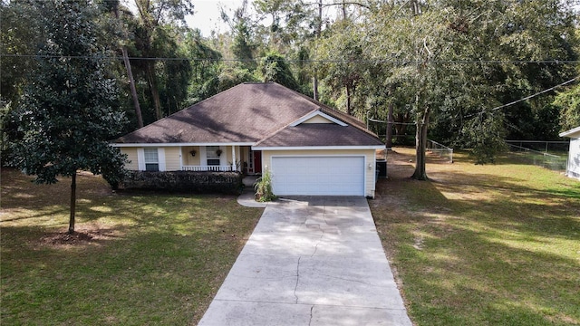 view of front facade featuring a porch, a front yard, and a garage