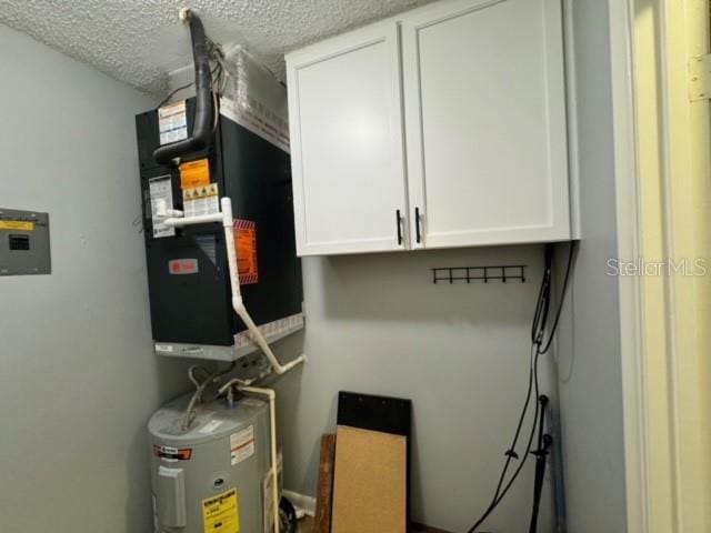 utility room with electric water heater