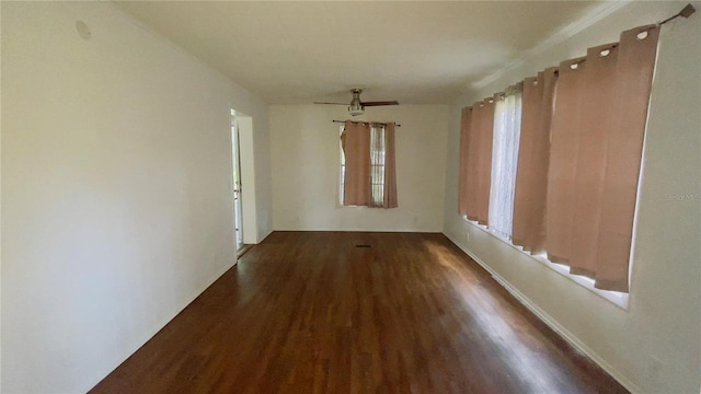 unfurnished room featuring ceiling fan and dark hardwood / wood-style flooring