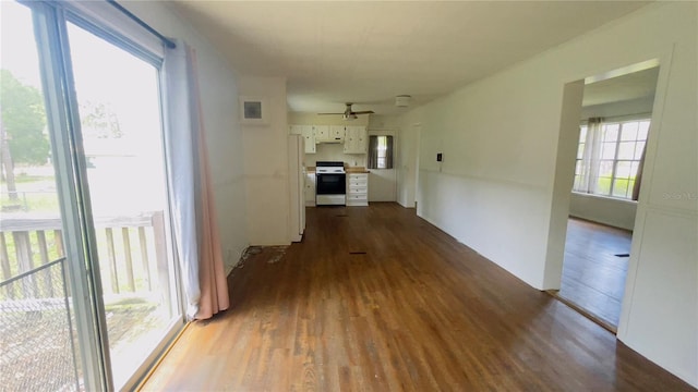 corridor with light wood-type flooring and a wealth of natural light