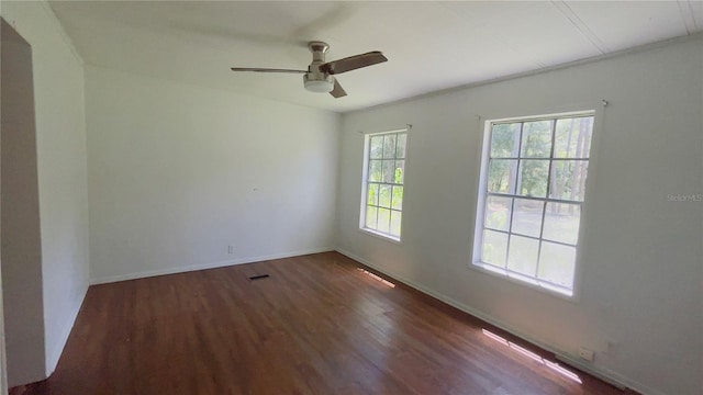 spare room featuring dark hardwood / wood-style floors and ceiling fan