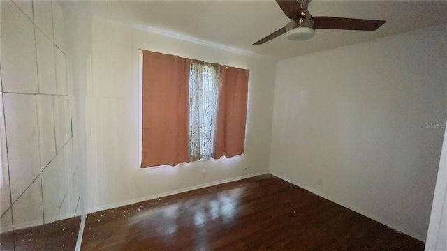 spare room with dark hardwood / wood-style flooring and ceiling fan