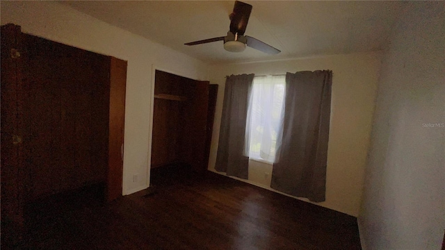 unfurnished bedroom with ceiling fan, a closet, and dark hardwood / wood-style floors