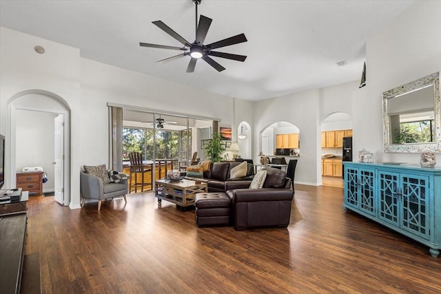 living room with dark hardwood / wood-style floors and ceiling fan