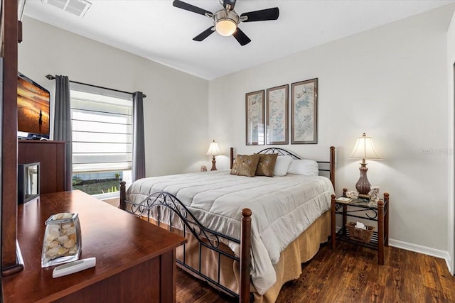 bedroom with ceiling fan and dark hardwood / wood-style flooring