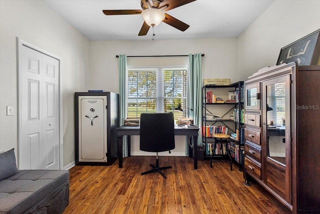 home office with dark hardwood / wood-style floors and ceiling fan