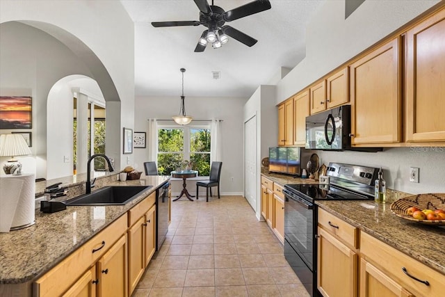 kitchen with sink, pendant lighting, stone countertops, light tile patterned floors, and black appliances