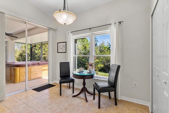 sitting room with light tile patterned floors, plenty of natural light, lofted ceiling, and ceiling fan