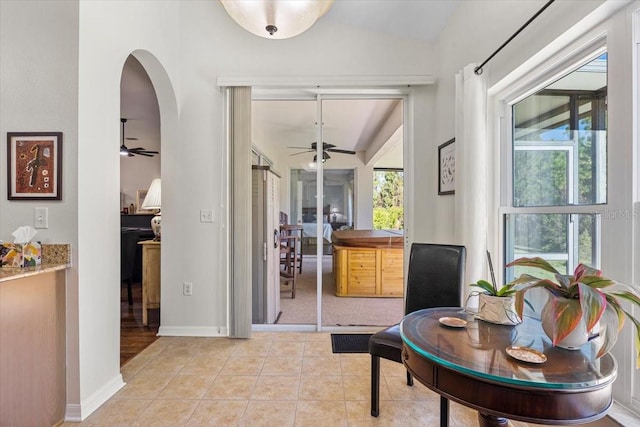 interior space with lofted ceiling and light tile patterned floors