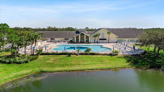 view of swimming pool with a yard, a water view, and a patio