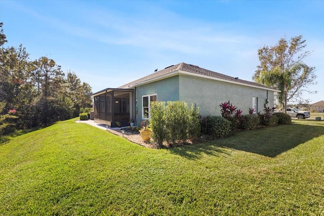 view of home's exterior featuring a sunroom and a yard