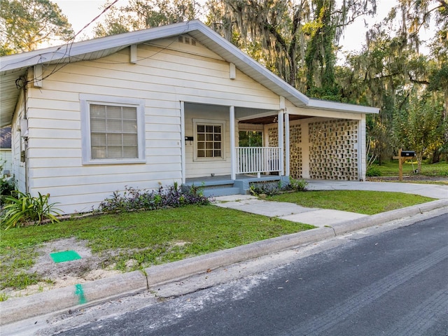 view of front of home featuring covered porch and a front yard