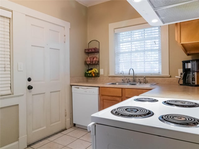 kitchen featuring dishwasher, light tile patterned floors, range hood, and sink