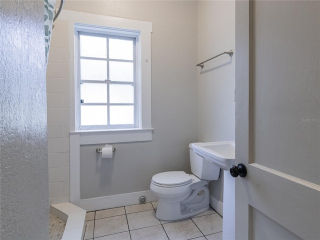 bathroom featuring tile patterned floors, walk in shower, and toilet